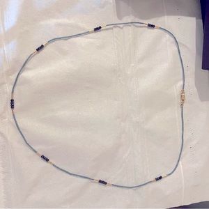 Brand new with box but no tag. Necklace gray and black.